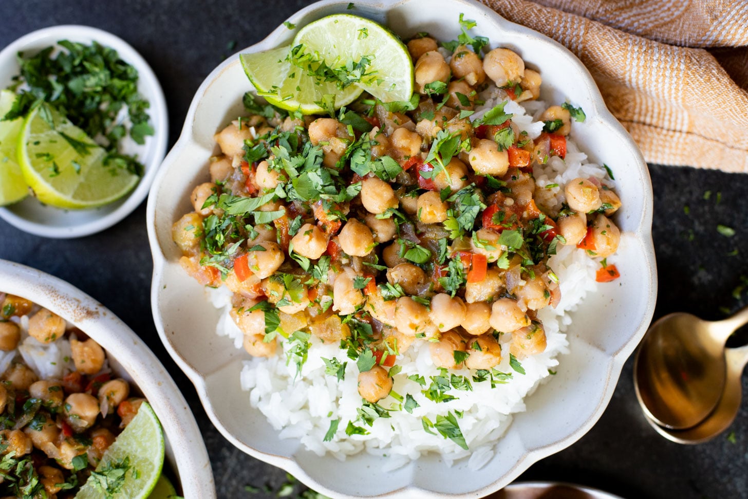 These Cilantro Lime Braised Chickpeas are simple, delicious and veggie-packed. Made in a dairy-free cream sauce and served over rice | ThisSavoryVegan.com #thissavoryvegan #easyvegandinners #quickdinnerideas