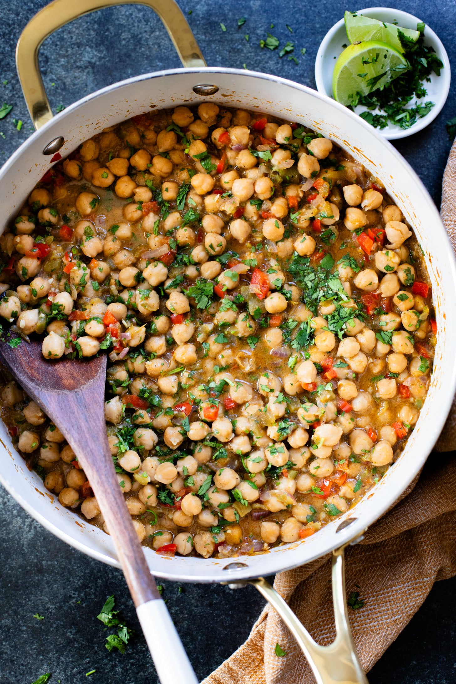 These Cilantro Lime Braised Chickpeas are simple, delicious and veggie-packed. Made in a dairy-free cream sauce and served over rice | ThisSavoryVegan.com #thissavoryvegan #easyvegandinners #quickdinnerideas