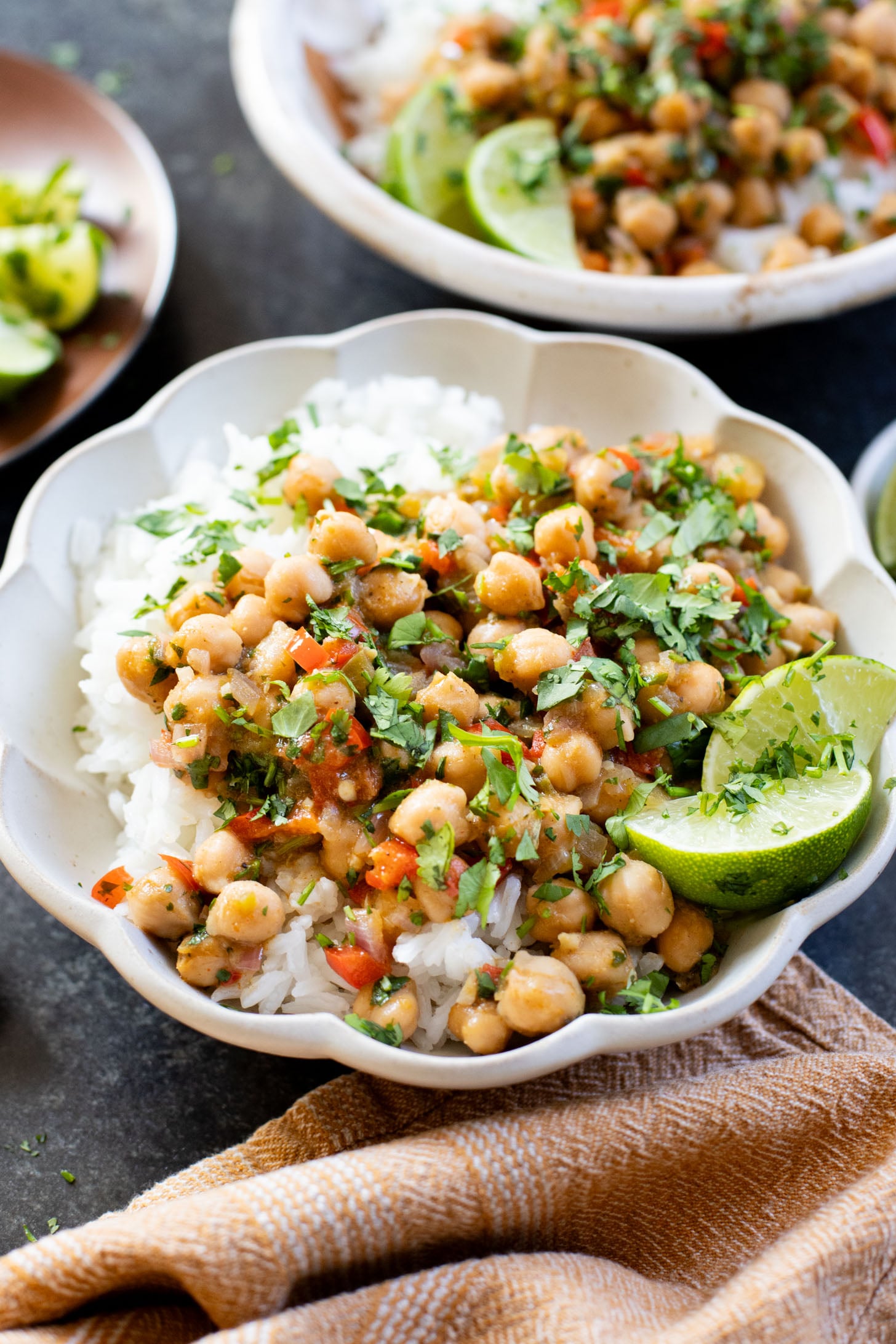 These Cilantro Lime Braised Chickpeas are simple, delicious and veggie-packed. Made in a dairy-free cream sauce and served over rice | ThisSavoryVegan.com #thissavoryvegan #easyvegandinners #quickdinnerideas