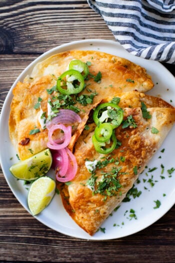 These Oven Baked Potato Tacos have a crispy outside & seasoned mashed potatoes inside. A perfect weeknight dinner when you want something easy | ThisSavoryVegan.com #thissavoryvegan #vegantacos #potatotacos