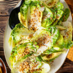 This Little Gem Caesar Salad is made with the best vegan Caesar dressing, garlic chickpea breadcrumbs, avocado slices & vegan parm | ThisSavoryVegan.com #vegancaesar #glutenfree #easysalads