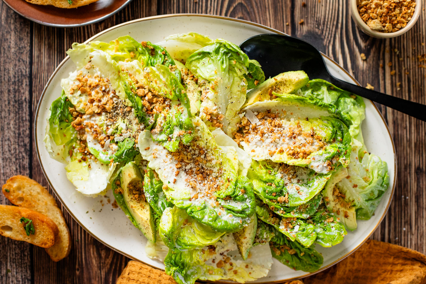 This Little Gem Caesar Salad is made with the best vegan Caesar dressing, garlic chickpea breadcrumbs, avocado slices & vegan parm | ThisSavoryVegan.com #vegancaesar #glutenfree #easysalads