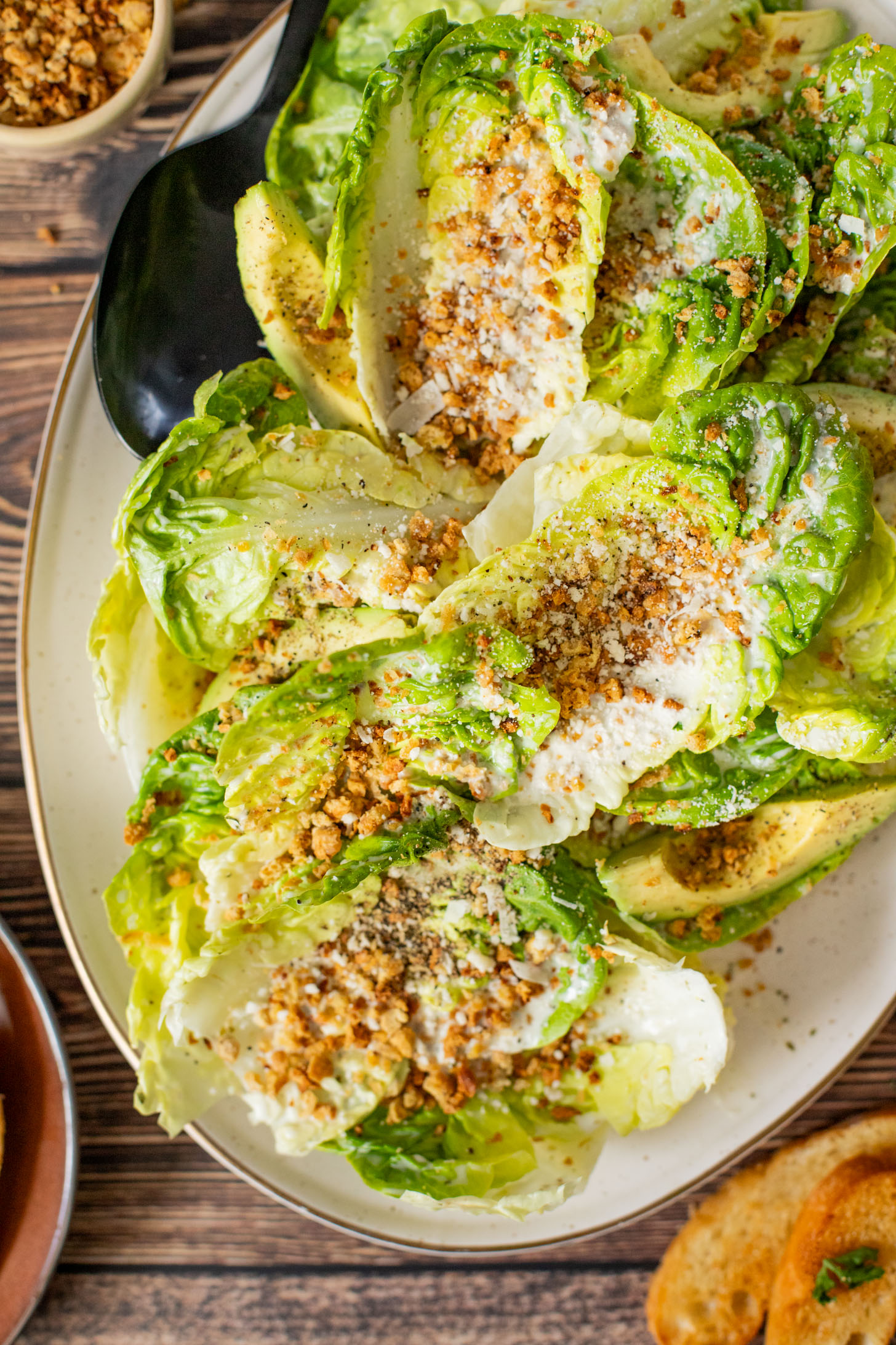 This Little Gem Caesar Salad is made with the best vegan Caesar dressing, garlic chickpea breadcrumbs, avocado slices & vegan parm | ThisSavoryVegan.com #vegancaesar #glutenfree #easysalads