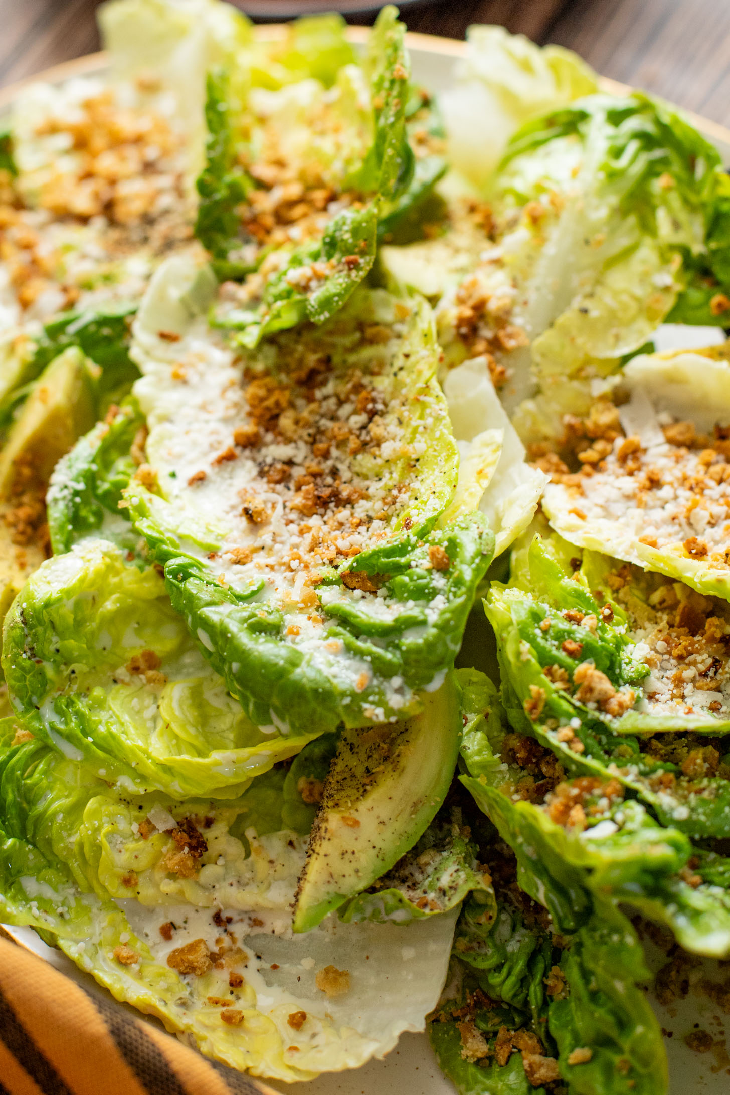 This Little Gem Caesar Salad is made with the best vegan Caesar dressing, garlic chickpea breadcrumbs, avocado slices & vegan parm | ThisSavoryVegan.com #vegancaesar #glutenfree #easysalads