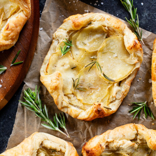 The perfect holiday appetizer - these Puff Pastry Potato Tarts have flakey crust, a creamy non-dairy spread & crispy rosemary potatoes | ThisSavoryVegan.com #thissavoryvegan #thanksgivingappetizers #holidaypartyfood