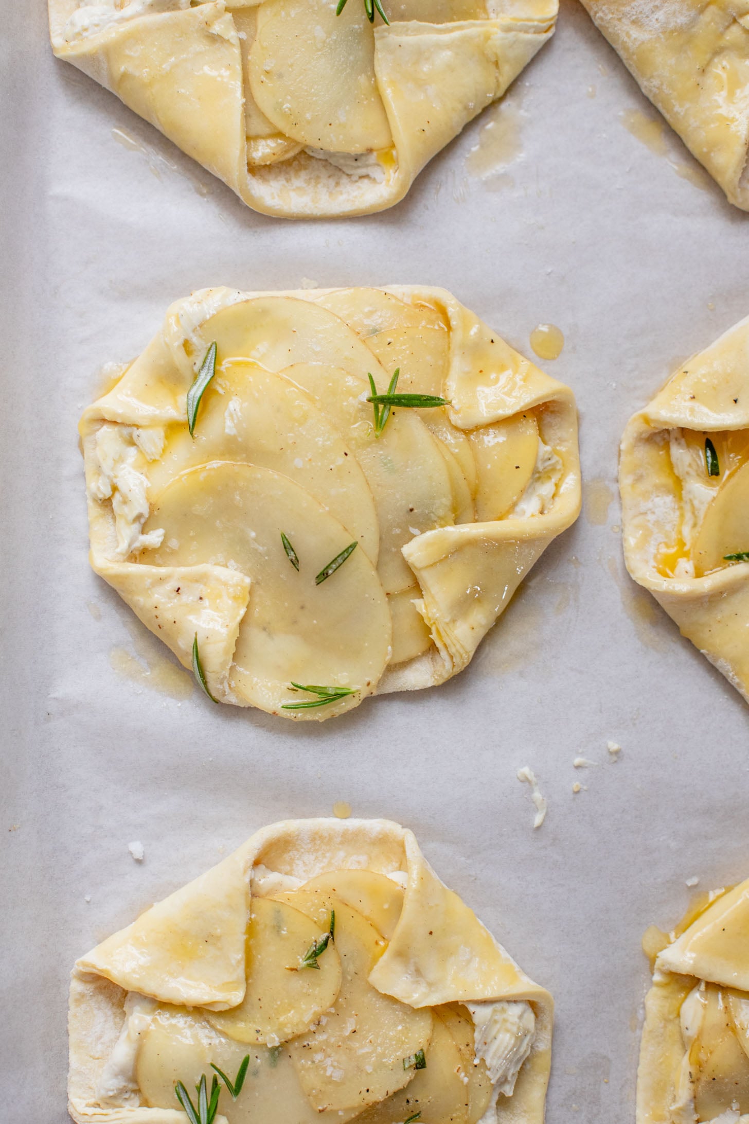 The perfect holiday appetizer - these Puff Pastry Potato Tarts have flakey crust, a creamy non-dairy spread & crispy rosemary potatoes | ThisSavoryVegan.com #thissavoryvegan #thanksgivingappetizers #holidaypartyfood