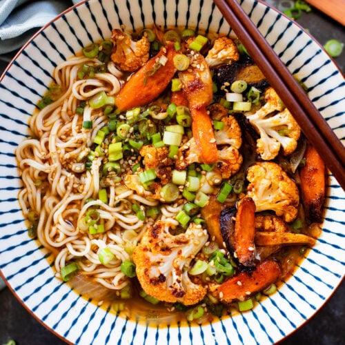 This Roasted Veggie Ramen is filled with crispy cauliflower & carrots in a delicious vegan broth. Finished off with tender ramen noodles for a cozy dinner | ThisSavoryVegan.com #thissavoryvegan #vegannramen #easyramenrecipe