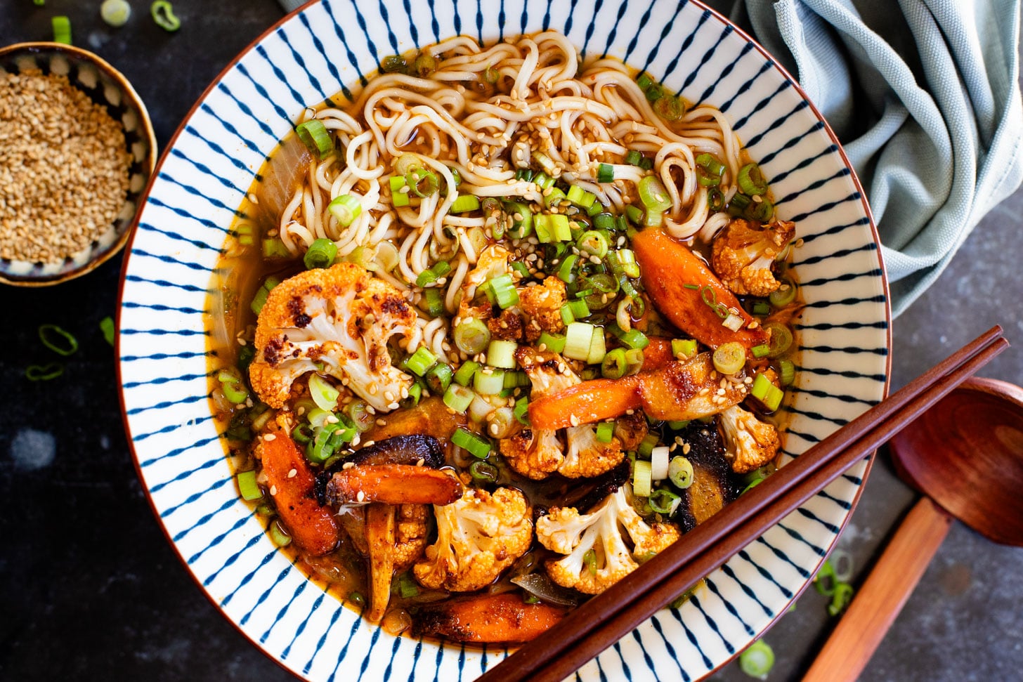 This Roasted Veggie Ramen is filled with crispy cauliflower & carrots in a delicious vegan broth. Finished off with tender ramen noodles for a cozy dinner | ThisSavoryVegan.com #thissavoryvegan #vegannramen #easyramenrecipe