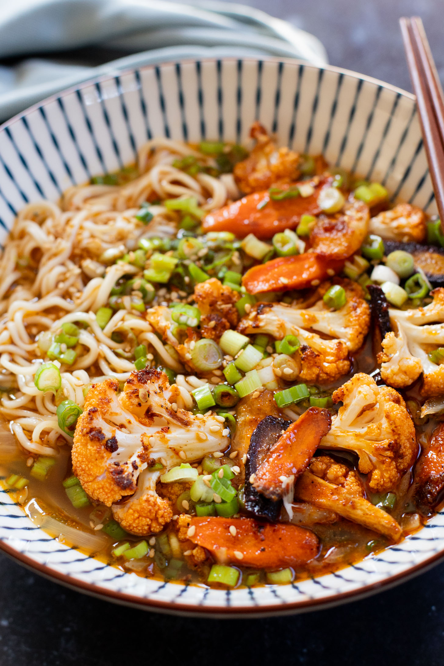 This Roasted Veggie Ramen is filled with crispy cauliflower & carrots in a delicious vegan broth. Finished off with tender ramen noodles for a cozy dinner | ThisSavoryVegan.com #thissavoryvegan #vegannramen #easyramenrecipe