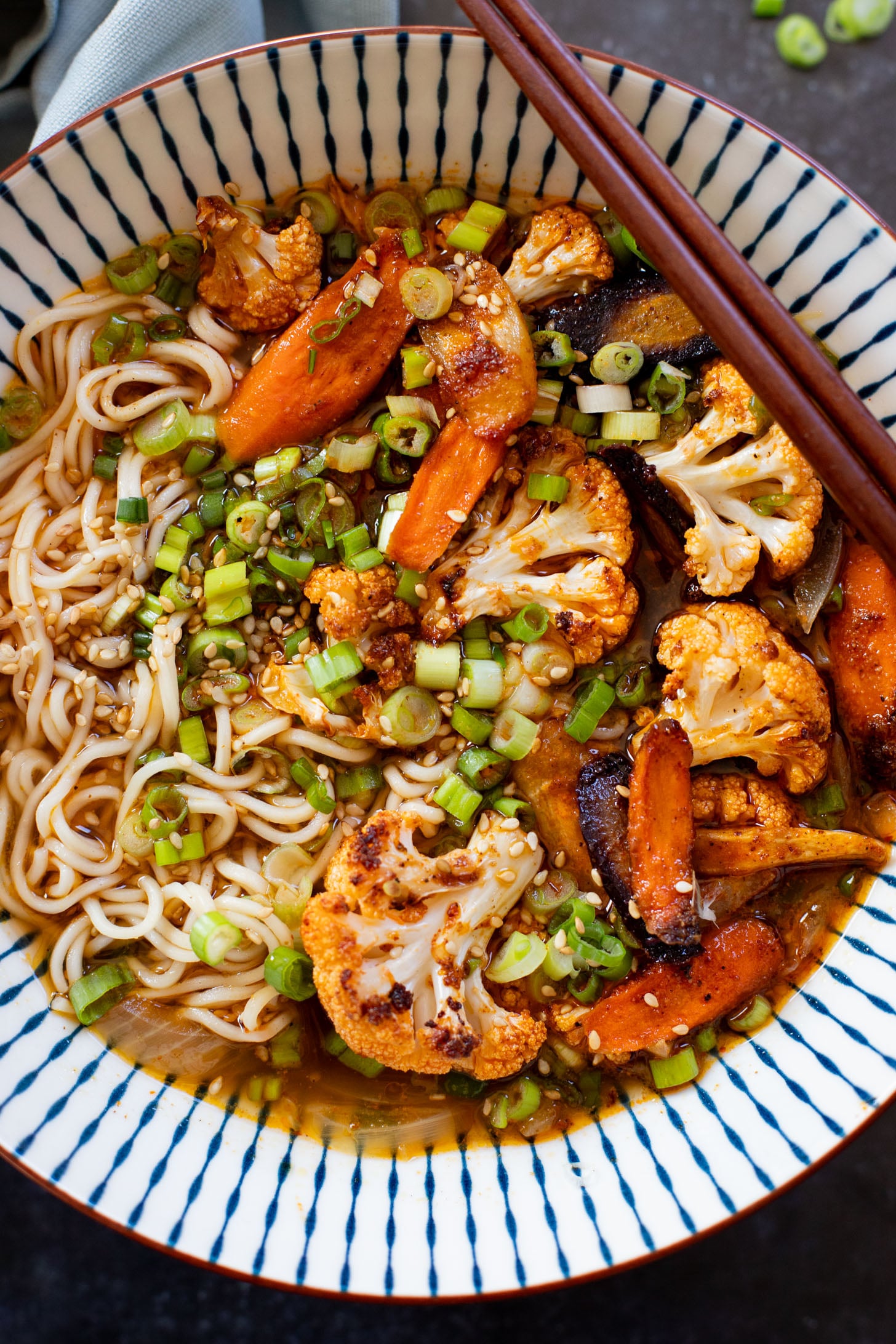 This Roasted Veggie Ramen is filled with crispy cauliflower & carrots in a delicious vegan broth. Finished off with tender ramen noodles for a cozy dinner | ThisSavoryVegan.com #thissavoryvegan #vegannramen #easyramenrecipe