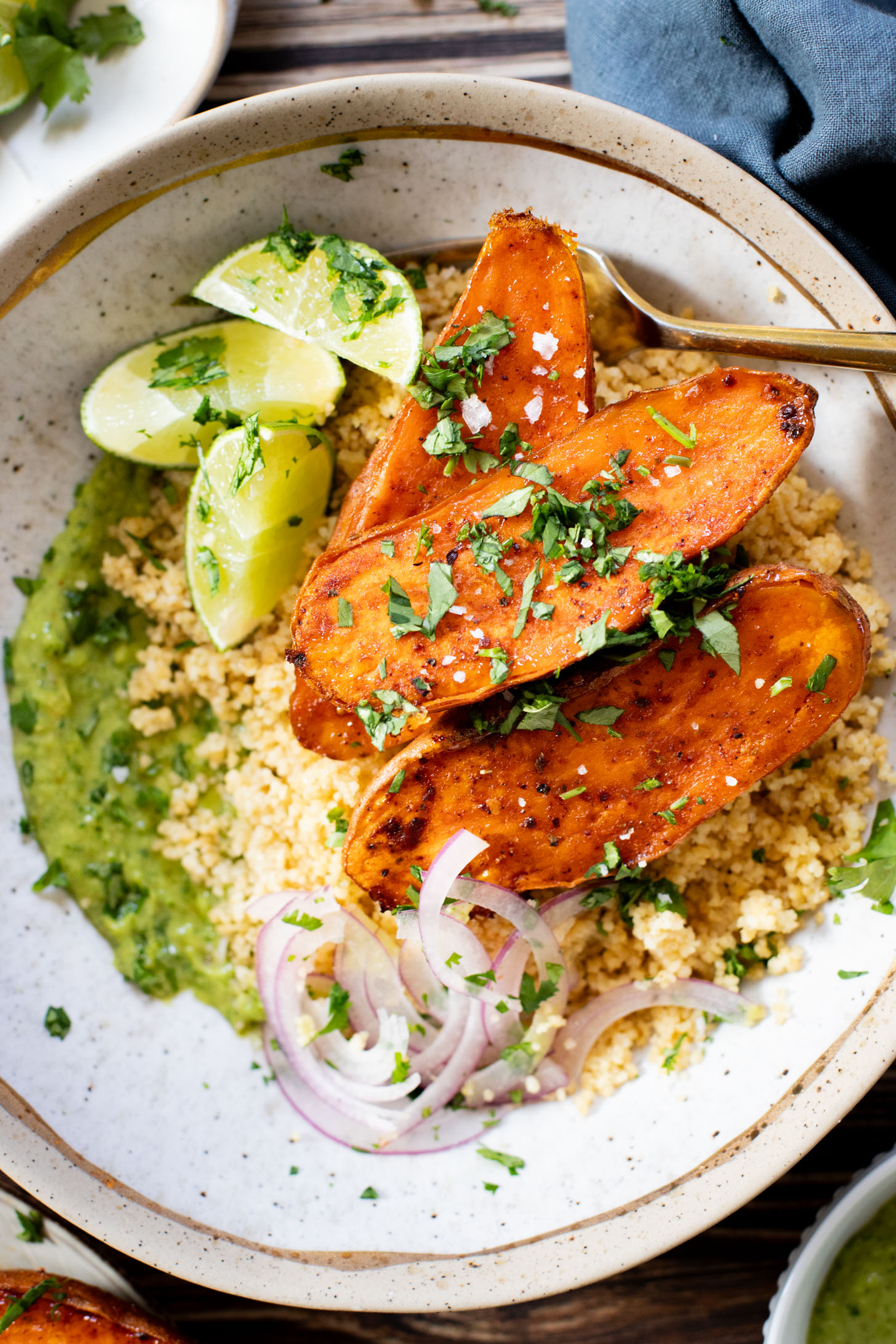 These Roasted Sweet Potato Bowls are layered with couscous, tender roasted sweet potatoes and an avocado cilantro sauce | ThisSavoryVegan.com #thissavoryvegan #grainbowl #veggiebowl