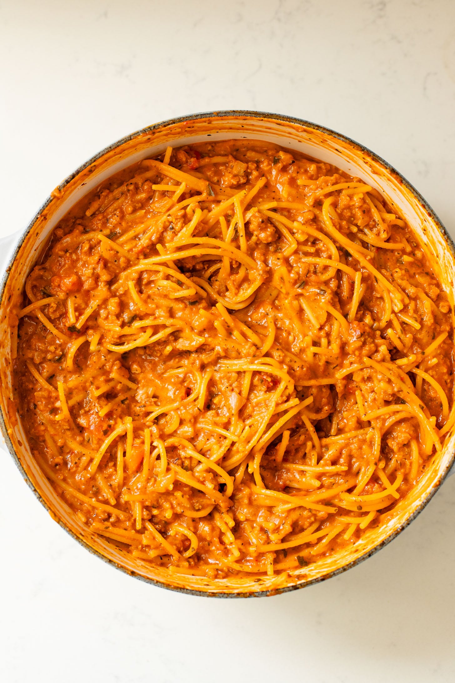 This Baked Spaghetti Bolognese is a one-pot vegan dinner that is comfort food at its best! Creamy pasta topped with melty vegan cheese | ThisSavoryVegan.com #pastabake #veganpasta #thissavoryvegan