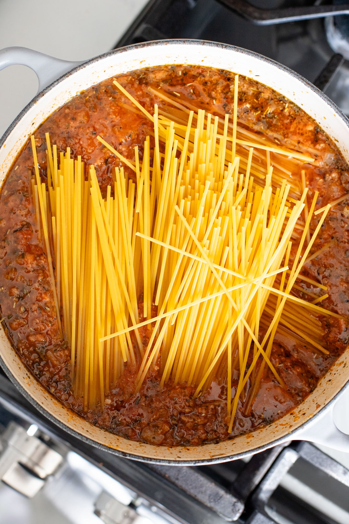 This Baked Spaghetti Bolognese is a one-pot vegan dinner that is comfort food at its best! Creamy pasta topped with melty vegan cheese | ThisSavoryVegan.com #pastabake #veganpasta #thissavoryvegan