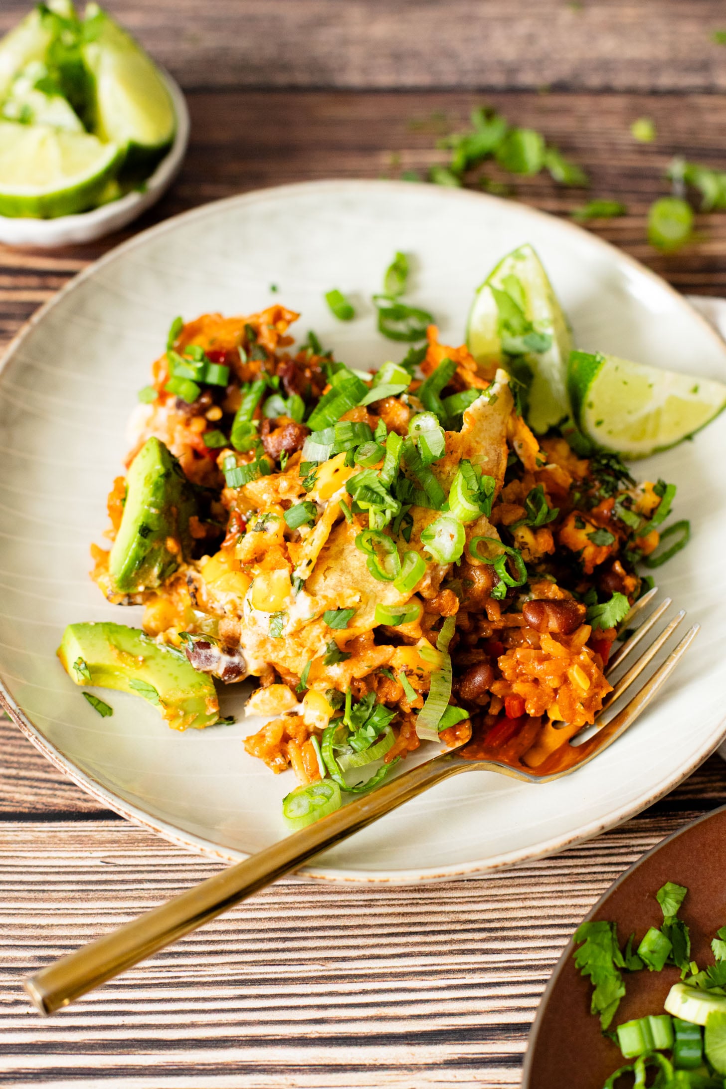 This Black Bean Tortilla Enchilada Rice Bake is a one-pot vegan dinner that is packed with veggies, rice, beans, corn salad and crispy tortillas | ThisSavoryVegan.com #thissavoryvegan #dumpandbake #vegancasserole