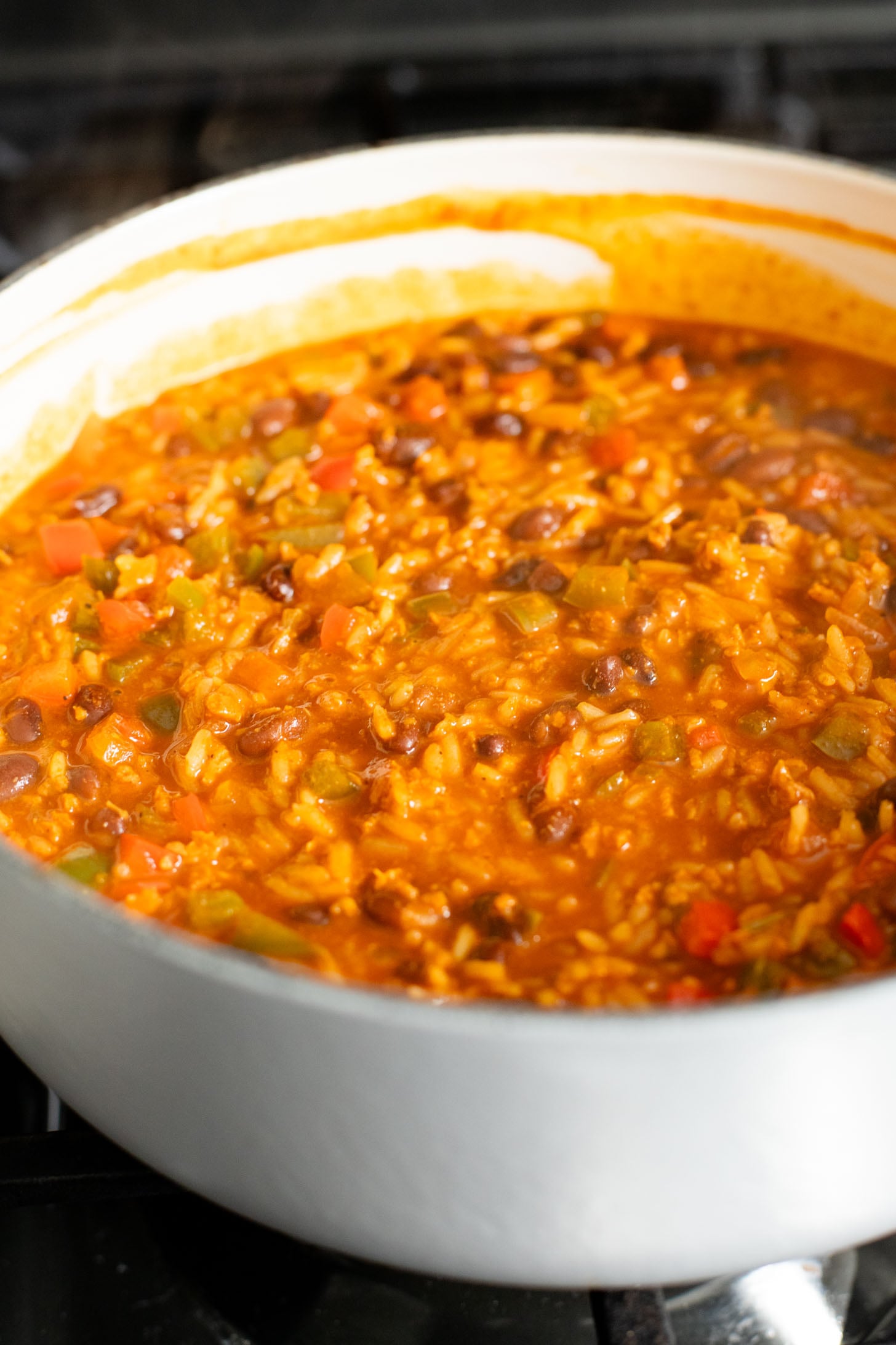 This Black Bean Tortilla Enchilada Rice Bake is a one-pot vegan dinner that is packed with veggies, rice, beans, corn salad and crispy tortillas | ThisSavoryVegan.com #thissavoryvegan #dumpandbake #vegancasserole