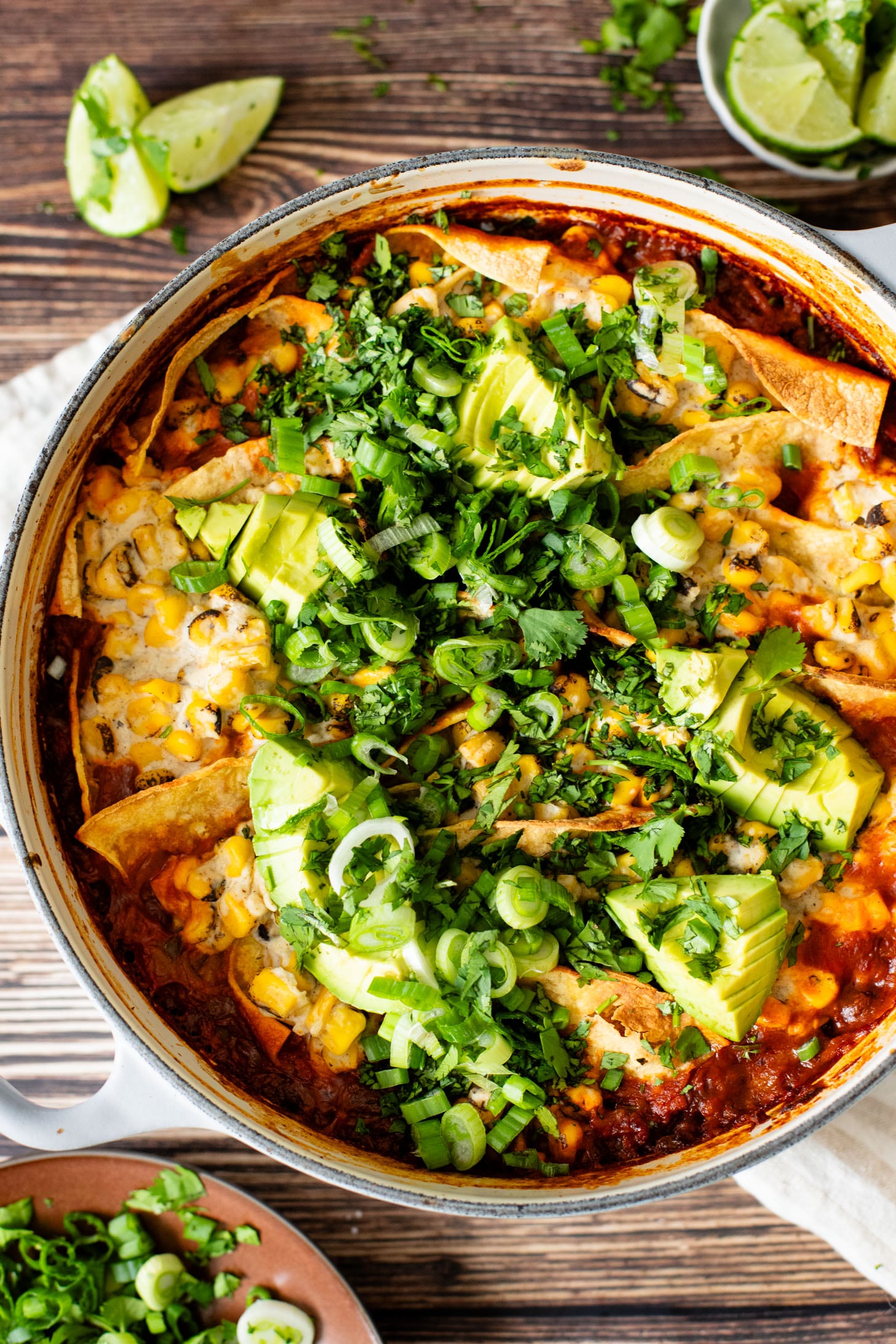 This Black Bean Tortilla Enchilada Rice Bake is a one-pot vegan dinner that is packed with veggies, rice, beans, corn salad and crispy tortillas | ThisSavoryVegan.com #thissavoryvegan #dumpandbake #vegancasserole