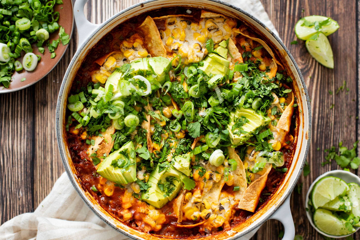 This Black Bean Tortilla Enchilada Rice Bake is a one-pot vegan dinner that is packed with veggies, rice, beans, corn salad and crispy tortillas | ThisSavoryVegan.com #thissavoryvegan #dumpandbake #vegancasserole