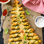 This Pesto Pull-Apart Christmas Tree is the best holiday appetizer! Filled with vegan pesto and topped with garlic butter | ThisSavoryVegan.com #christmasrecipes #christmasappetizers #holidaypartyfood