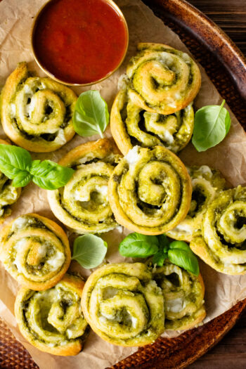 The perfect party appetizer, these Vegan Pesto & Feta Pinwheels only require 4 ingredients and 25 minutes. Tasty and simple | ThisSavoryVegan.com #thissavoryvegan #veganappetizers #holidayappetizers