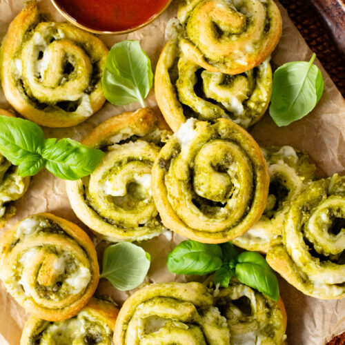 The perfect party appetizer, these Vegan Pesto & Feta Pinwheels only require 4 ingredients and 25 minutes. Tasty and simple | ThisSavoryVegan.com #thissavoryvegan #veganappetizers #holidayappetizers