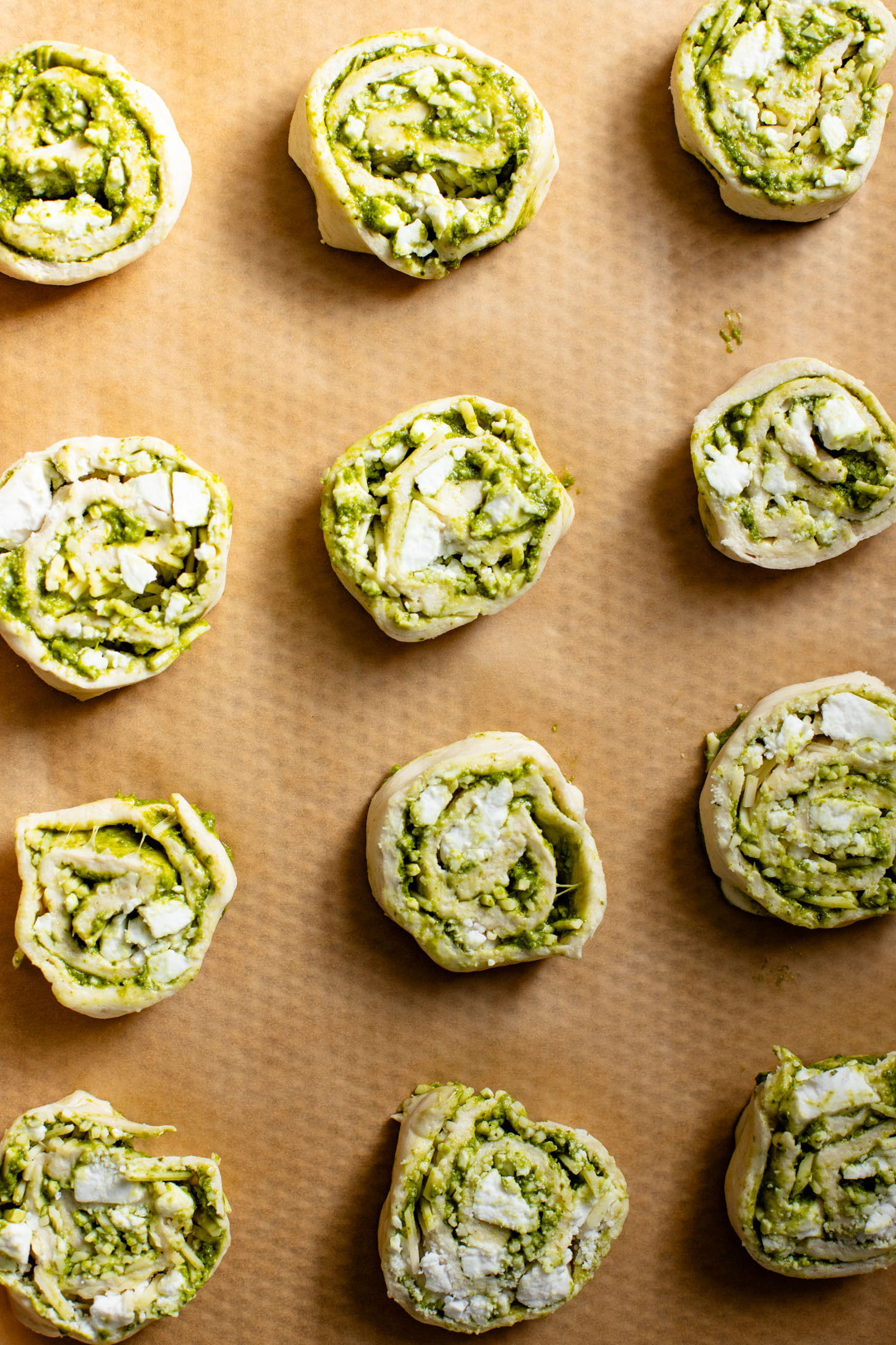 The perfect party appetizer, these Vegan Pesto & Feta Pinwheels only require 4 ingredients and 25 minutes. Tasty and simple | ThisSavoryVegan.com #thissavoryvegan #veganappetizers #holidayappetizers