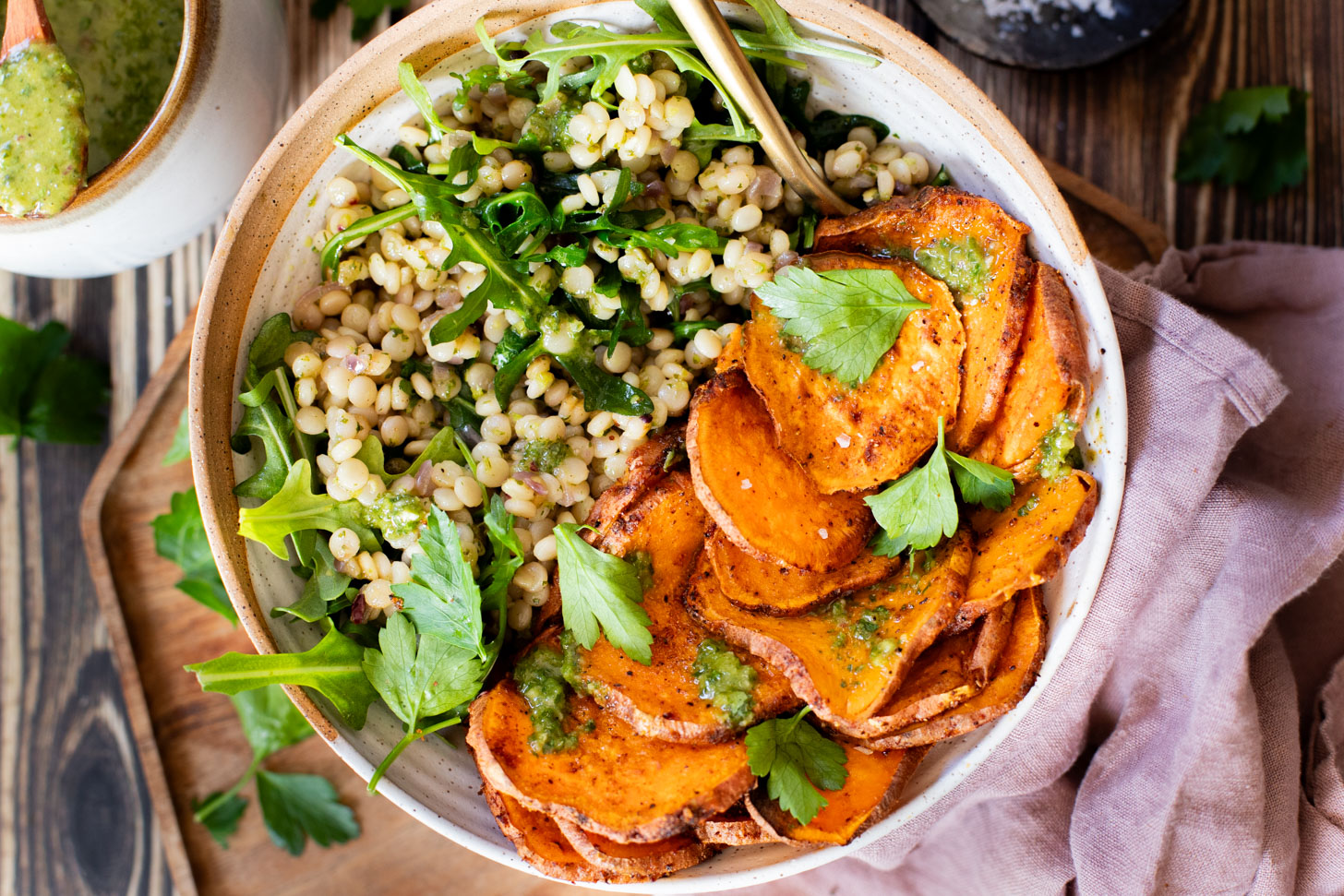 This Chimichurri Couscous & Roasted Sweet Potatoes recipe is healthy, comfort food. Pearl couscous tossed in homemade chimichurri & topped with seasoned sweet potatoes | ThisSavoryVegan.com #thissavoryvegan #couscousrecipes #roastedpotatoes