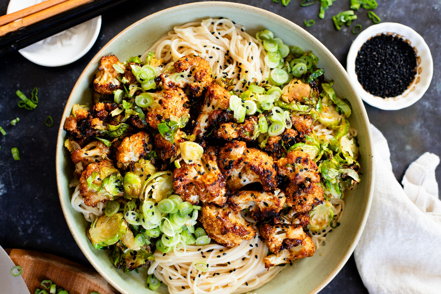 This Hoisin Cauliflower & Coconut Rice Noodles recipe is better than takeout! Coconut rice noodles are topped with crispy cauliflower & roasted brussels sprouts | ThisSavoryVegan.com #thissavoryvegan #cauliflowerrecipes #vegantakeoutrecipes