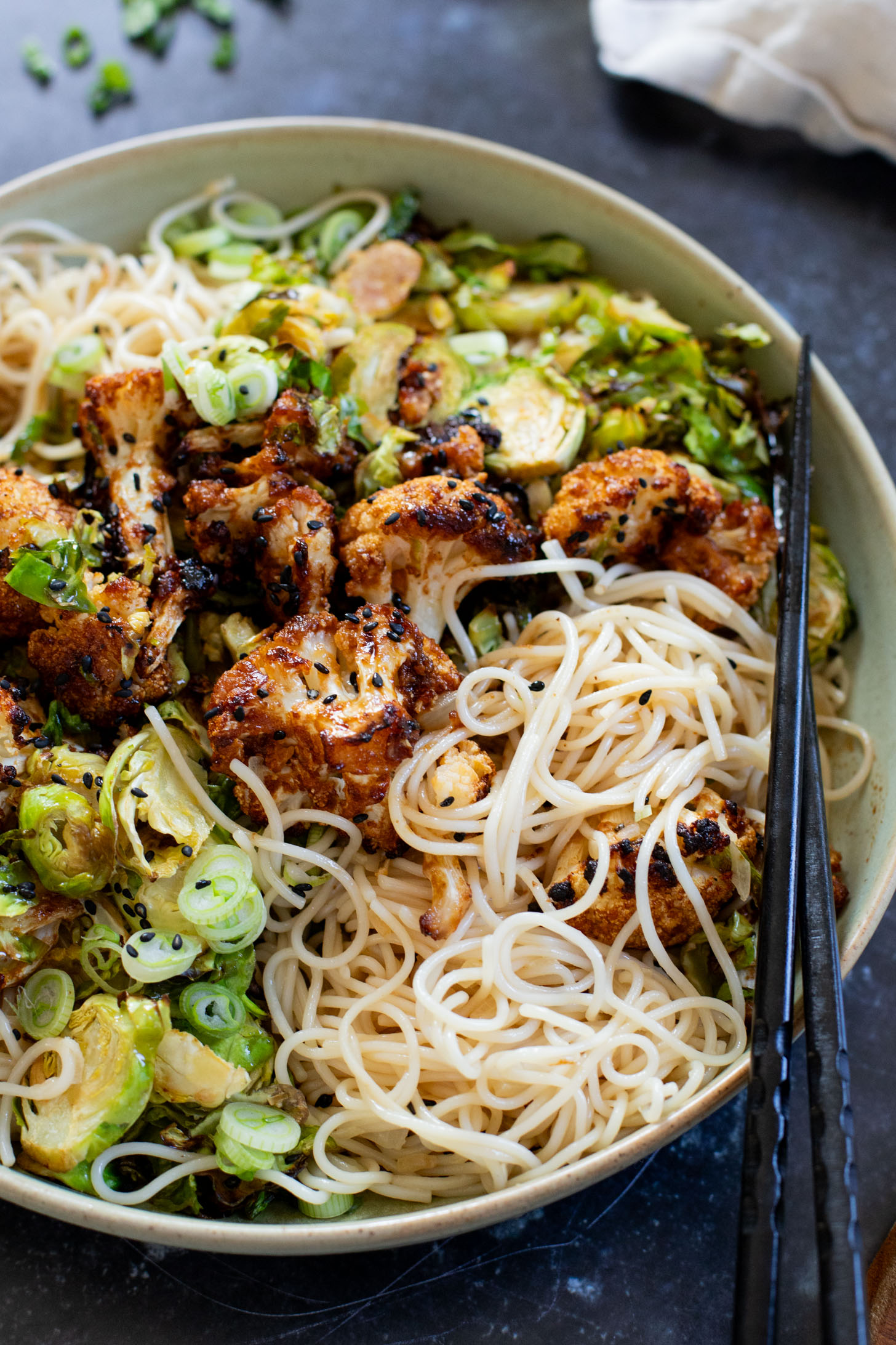 This Hoisin Cauliflower & Coconut Rice Noodles recipe is better than takeout! Coconut rice noodles are topped with crispy cauliflower & roasted brussels sprouts | ThisSavoryVegan.com #thissavoryvegan #cauliflowerrecipes #vegantakeoutrecipes