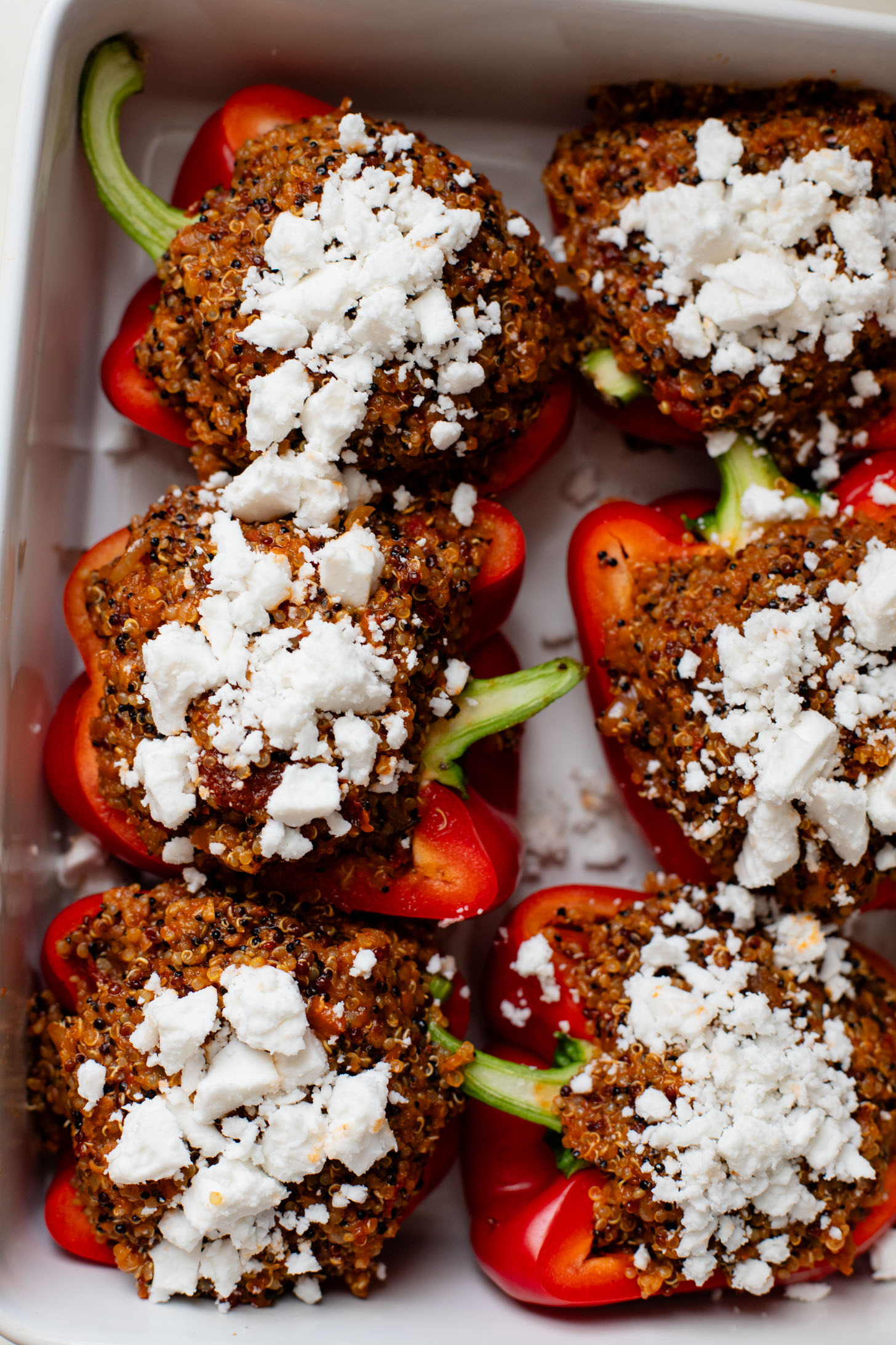 These Mediterranean Quinoa Stuffed Peppers are loaded with quinoa, vegan sausage & non-dairy feta. A delicious and veggie-packed vegan dinner | ThisSavoryVegan.com #thissavoryvegan #stuffedpeppers #highproteinveganrecipes