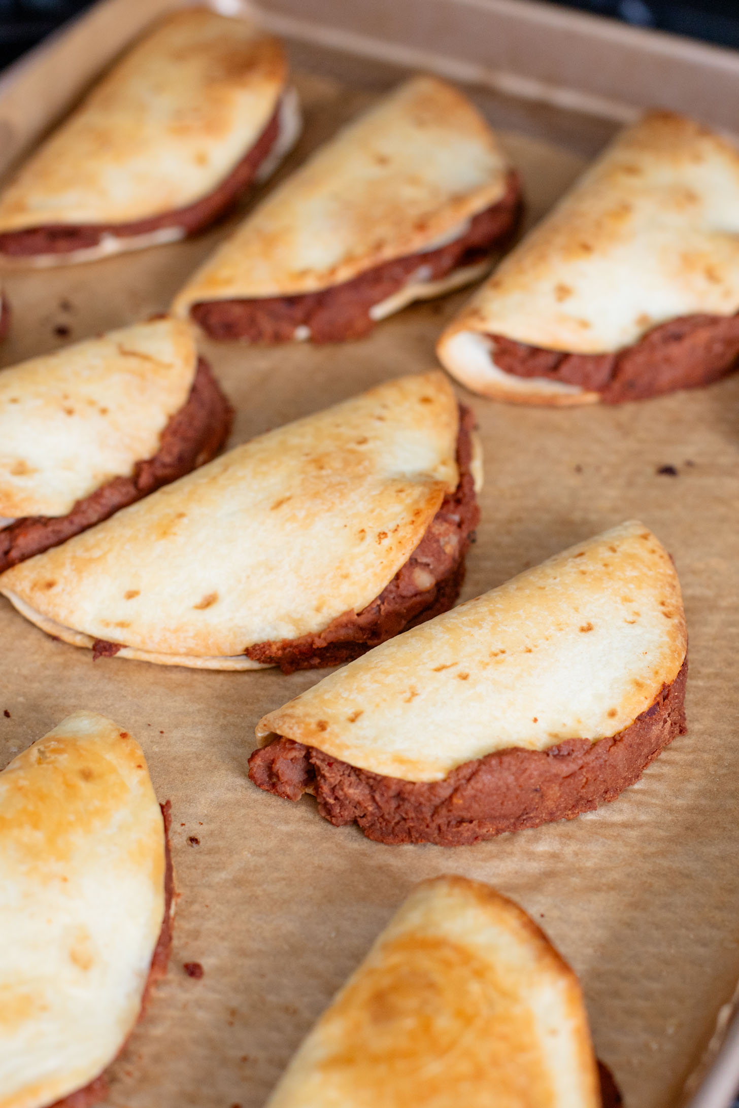 These Mini Refried Bean Tacos are INCREDIBLY simple to make, so tasty and perfect for an easy dinner or game day snack | ThisSavoryVegan.com #thissavoryvegan #vegantacos #gamedaysnacks