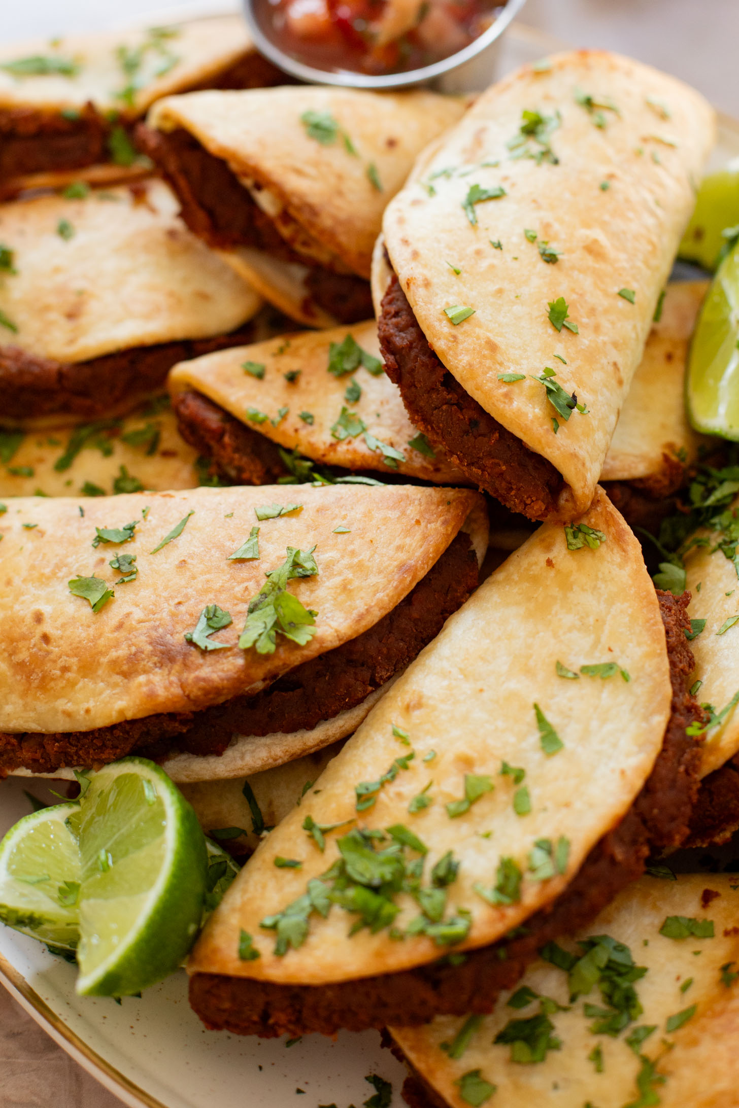 These Mini Refried Bean Tacos are INCREDIBLY simple to make, so tasty and perfect for an easy dinner or game day snack | ThisSavoryVegan.com #thissavoryvegan #vegantacos #gamedaysnacks