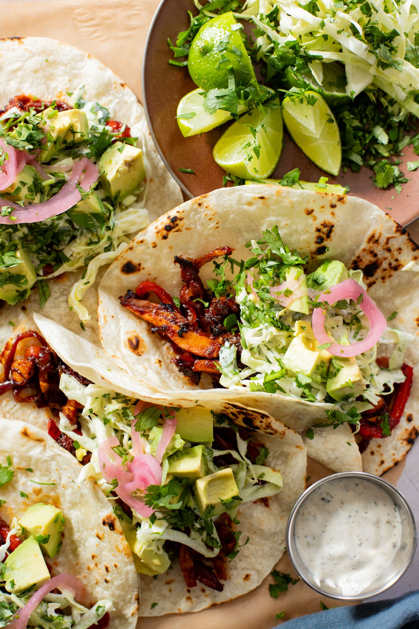 These Oyster Mushroom BBQ Tacos are vegan taco goals! Shredded mushrooms are tossed in BBQ sauce & topped with vegan slaw & avocado | ThisSavoryVegan.com #thissavoryvegan #vegantacos #mushroomtacos