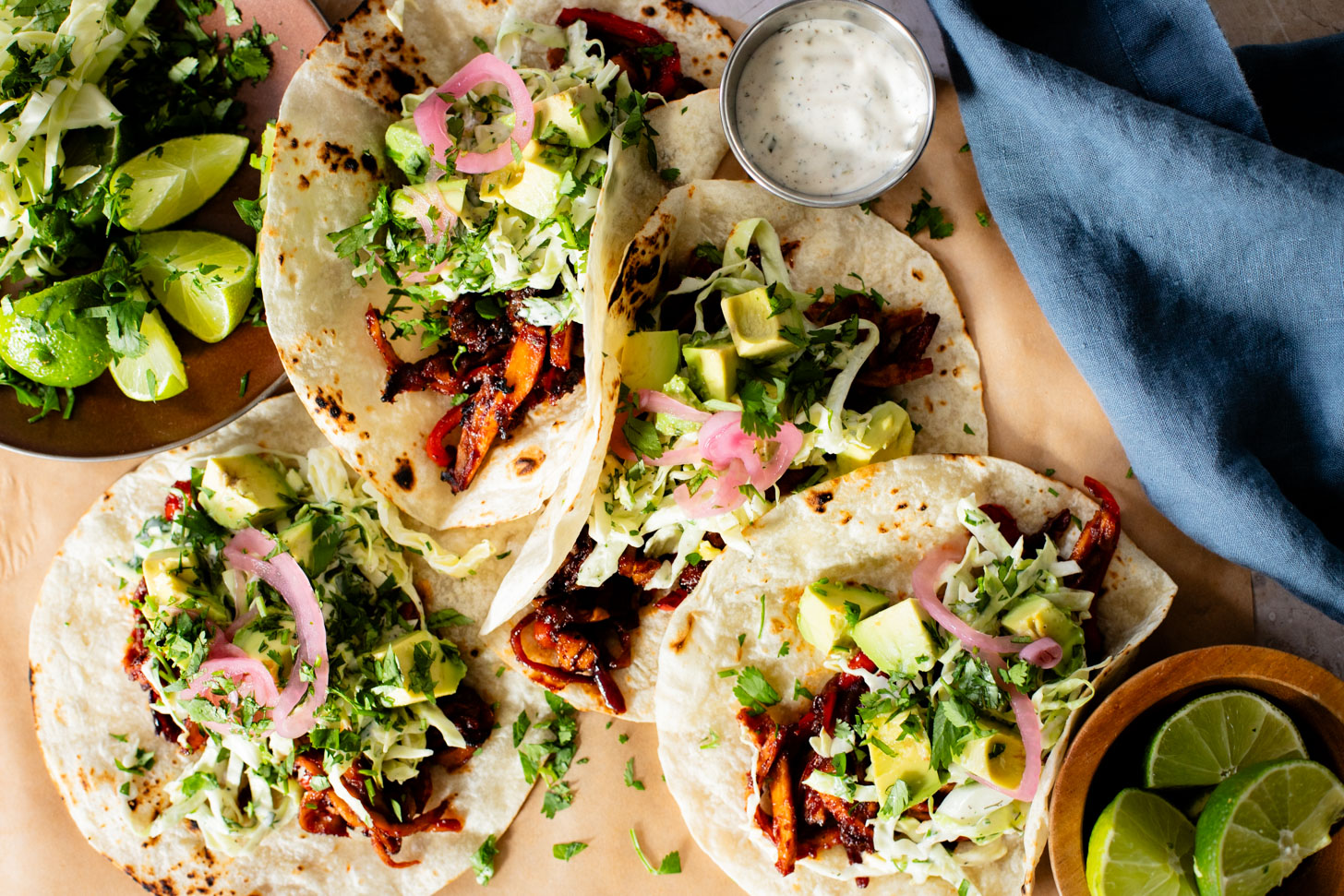 These Oyster Mushroom BBQ Tacos are vegan taco goals! Shredded mushrooms are tossed in BBQ sauce & topped with vegan slaw & avocado | ThisSavoryVegan.com #thissavoryvegan #vegantacos #mushroomtacos