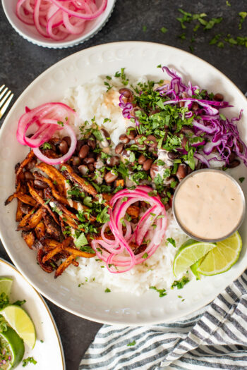 These Oyster Mushroom Burrito Bowls are made with shredded crispy king oyster mushrooms, rice, beans & chipotle ranch | ThisSavoryVegan.com #thissavoryvegan #veganburritobowls #mushroomrecipes