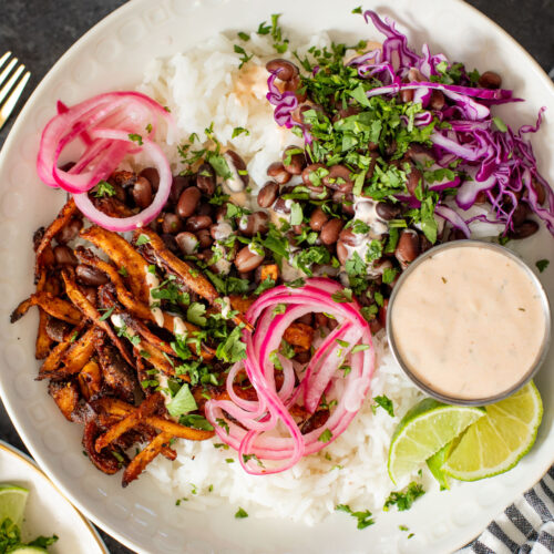 These Oyster Mushroom Burrito Bowls are made with shredded crispy king oyster mushrooms, rice, beans & chipotle ranch | ThisSavoryVegan.com #thissavoryvegan #veganburritobowls #mushroomrecipes