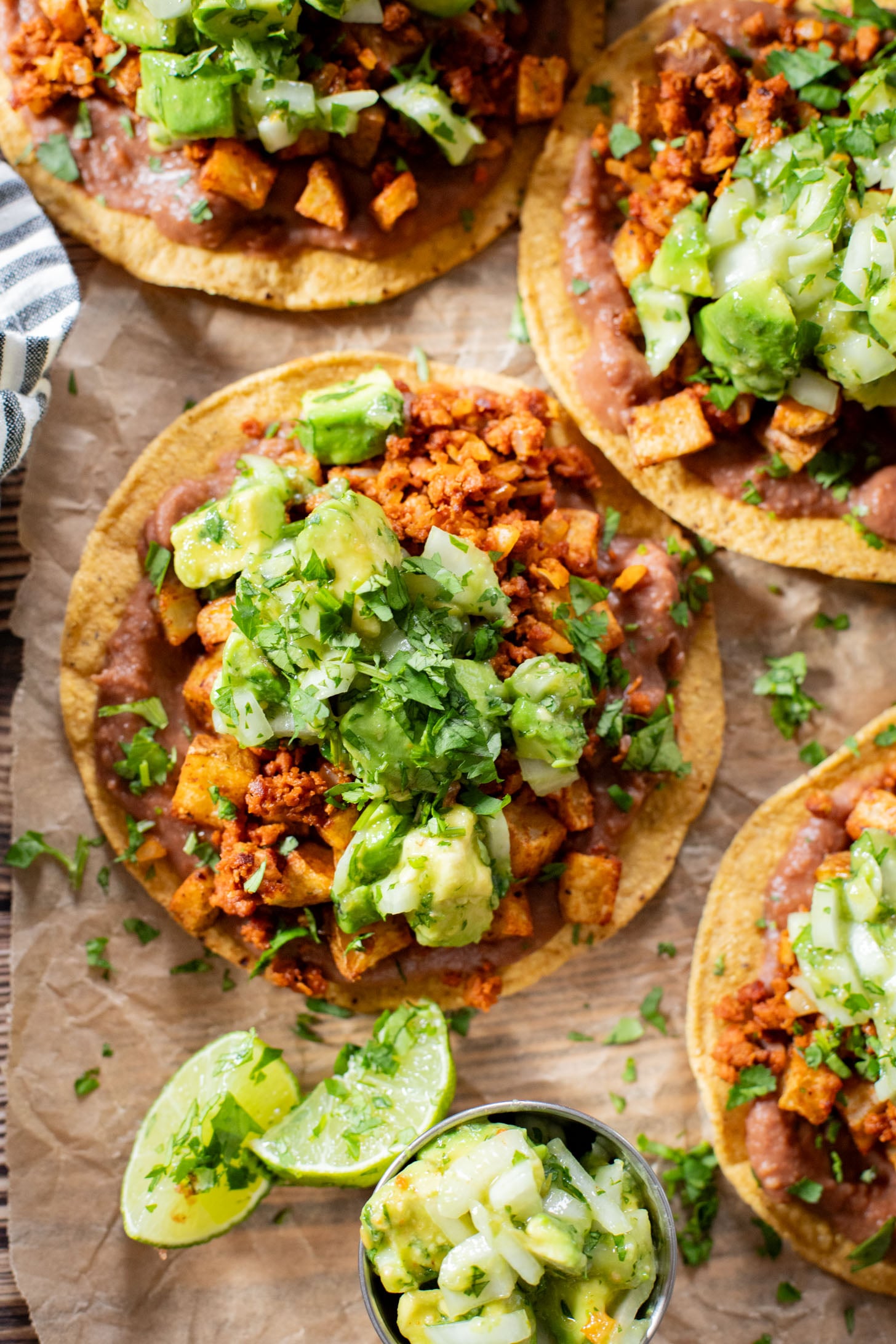 These Soy Chorizo & Potato Tostadas are made with refried beans, crispy potatoes, soyrizo and a salsa verde avocado salsa | ThisSavoryVegan.com #thissavoryvegan #vegantostadas #veganmexicanfood