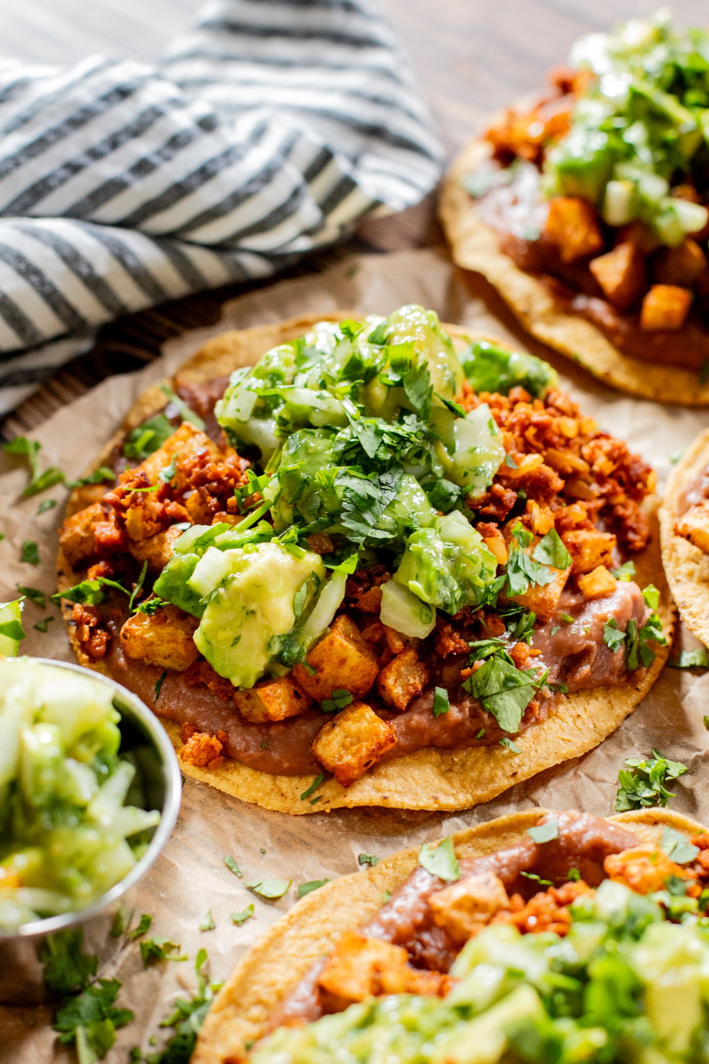These Soy Chorizo & Potato Tostadas are made with refried beans, crispy potatoes, soyrizo and a salsa verde avocado salsa | ThisSavoryVegan.com #thissavoryvegan #vegantostadas #veganmexicanfood