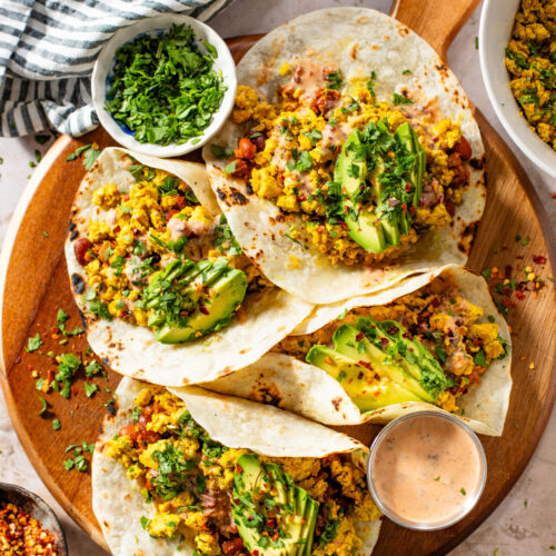 These Tofu Scramble Tacos are layered with seasoned scrambled tofu, soyrizo, pinto beans, avocado and a dairy-free chipotle ranch | ThisSavoryVegan.com #thissavoryvegan #vegantacos #veganbrunchideas