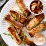 These Vegan Korean Beef Egg Rolls are the perfect party appetizer! Baked until crispy and served with sriracha mayo on the side for dipping | ThisSavoryVegan.com #thissavoryvegan #veganeggrolls #veganpartyfood