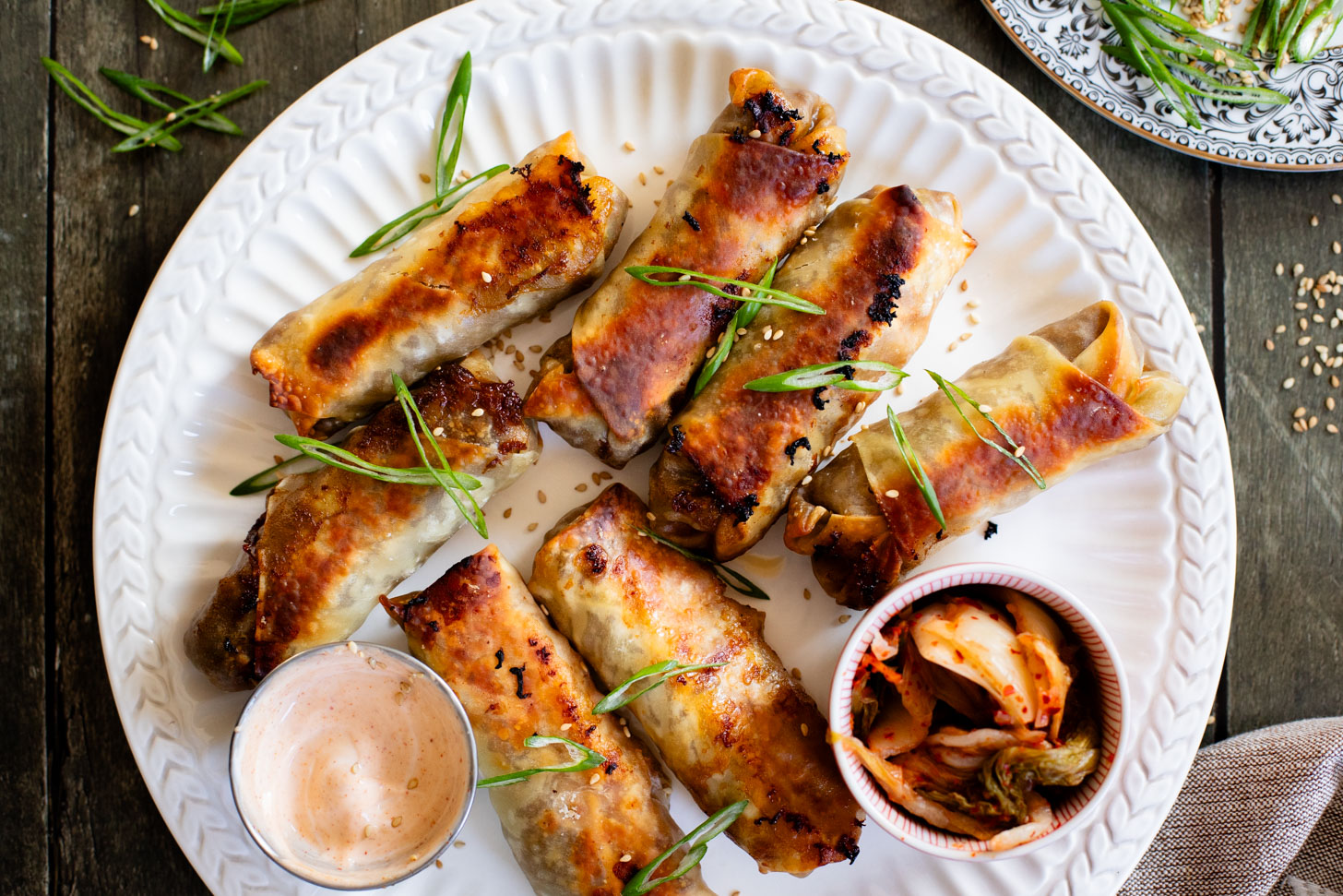 These Vegan Korean Beef Egg Rolls are the perfect party appetizer! Baked until crispy and served with sriracha mayo on the side for dipping | ThisSavoryVegan.com #thissavoryvegan #veganeggrolls #veganpartyfood