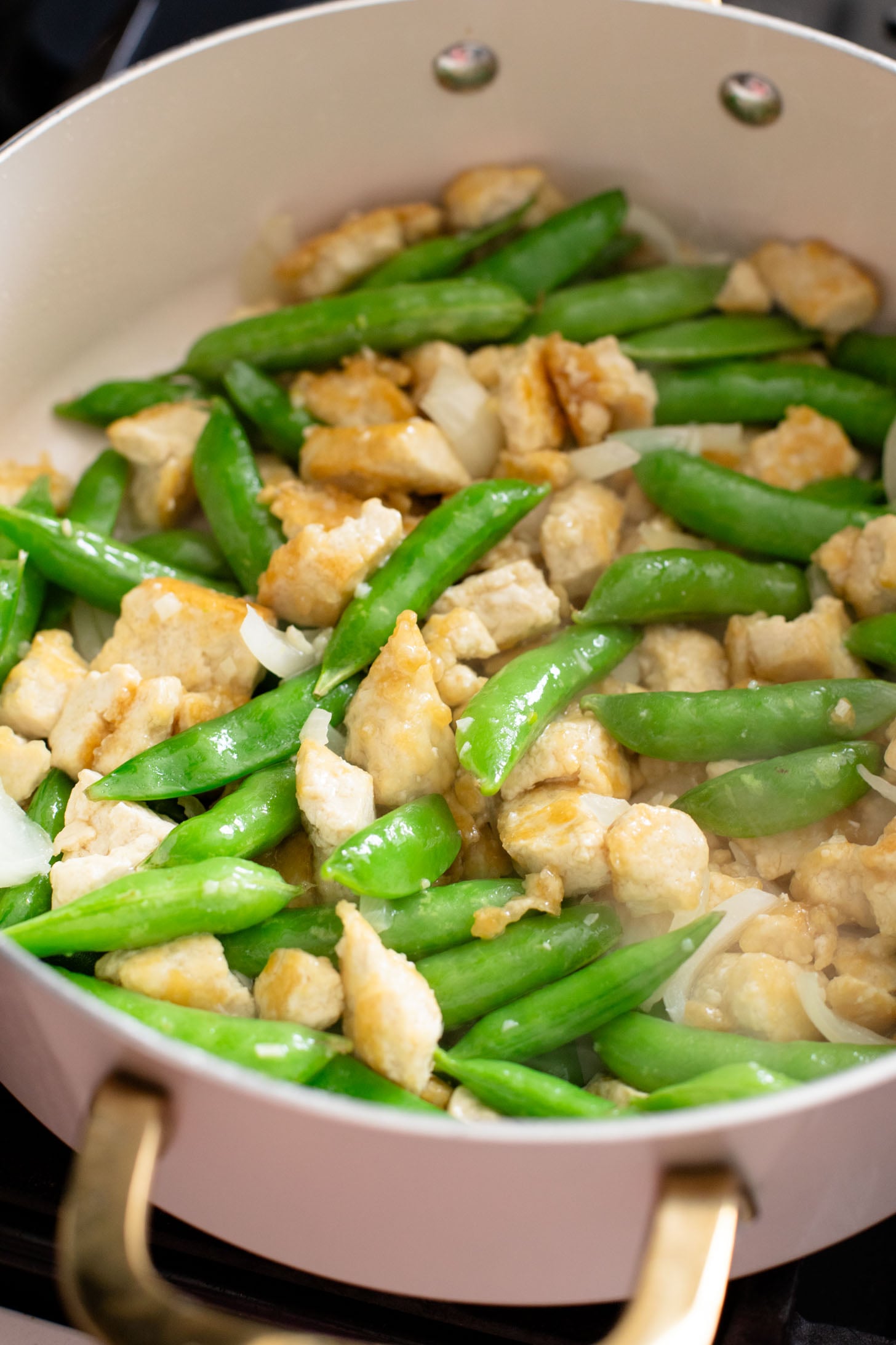This Gochujang Tofu & Snap Peas recipe has crispy tofu & snap peas tossed in a tasty gochujang sauce. Served over rice with spicy mayo | ThisSavoryVegan.com #thissavoryvegan #crispytofu #veganasianinspired