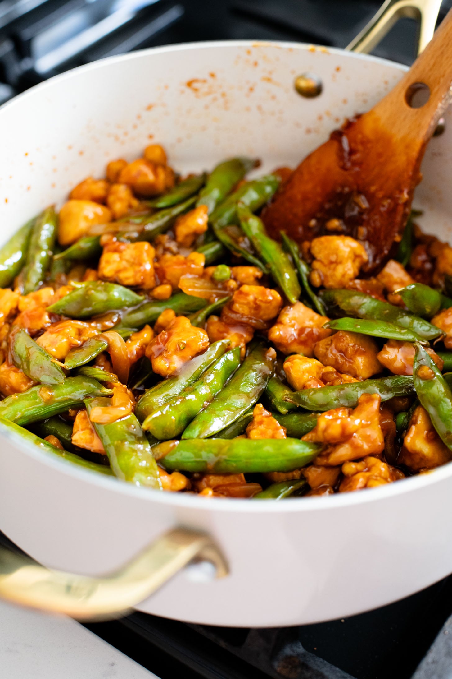 This Gochujang Tofu & Snap Peas recipe has crispy tofu & snap peas tossed in a tasty gochujang sauce. Served over rice with spicy mayo | ThisSavoryVegan.com #thissavoryvegan #crispytofu #veganasianinspired