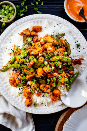 This Gochujang Tofu & Snap Peas recipe has crispy tofu & snap peas tossed in a tasty gochujang sauce. Served over rice with spicy mayo | ThisSavoryVegan.com #thissavoryvegan #crispytofu #veganasianinspired