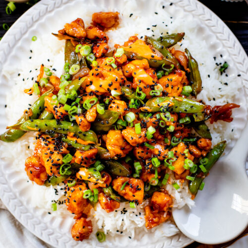 This Gochujang Tofu & Snap Peas recipe has crispy tofu & snap peas tossed in a tasty gochujang sauce. Served over rice with spicy mayo | ThisSavoryVegan.com #thissavoryvegan #crispytofu #veganasianinspired