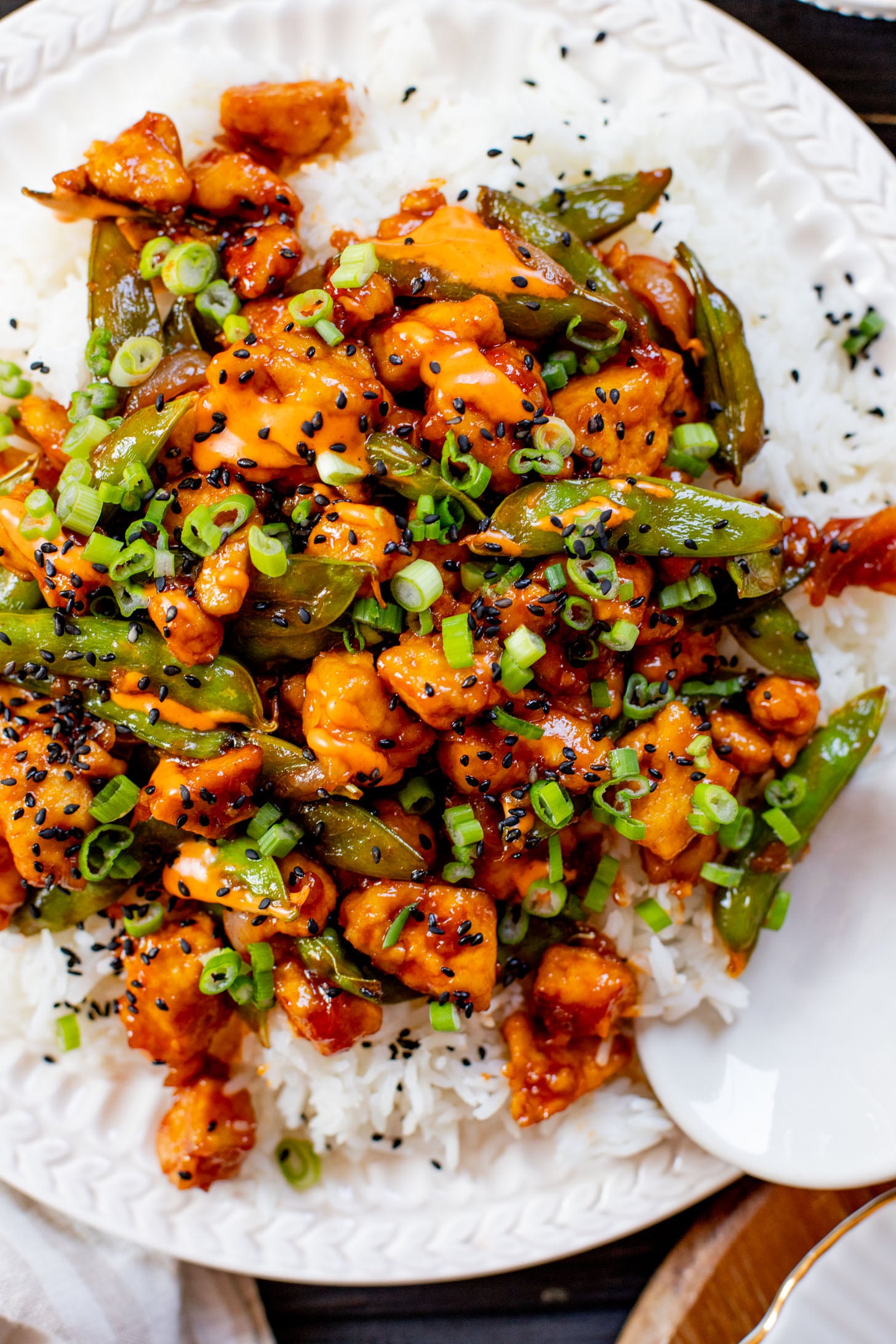 This Gochujang Tofu & Snap Peas recipe has crispy tofu & snap peas tossed in a tasty gochujang sauce. Served over rice with spicy mayo | ThisSavoryVegan.com #thissavoryvegan #crispytofu #veganasianinspired