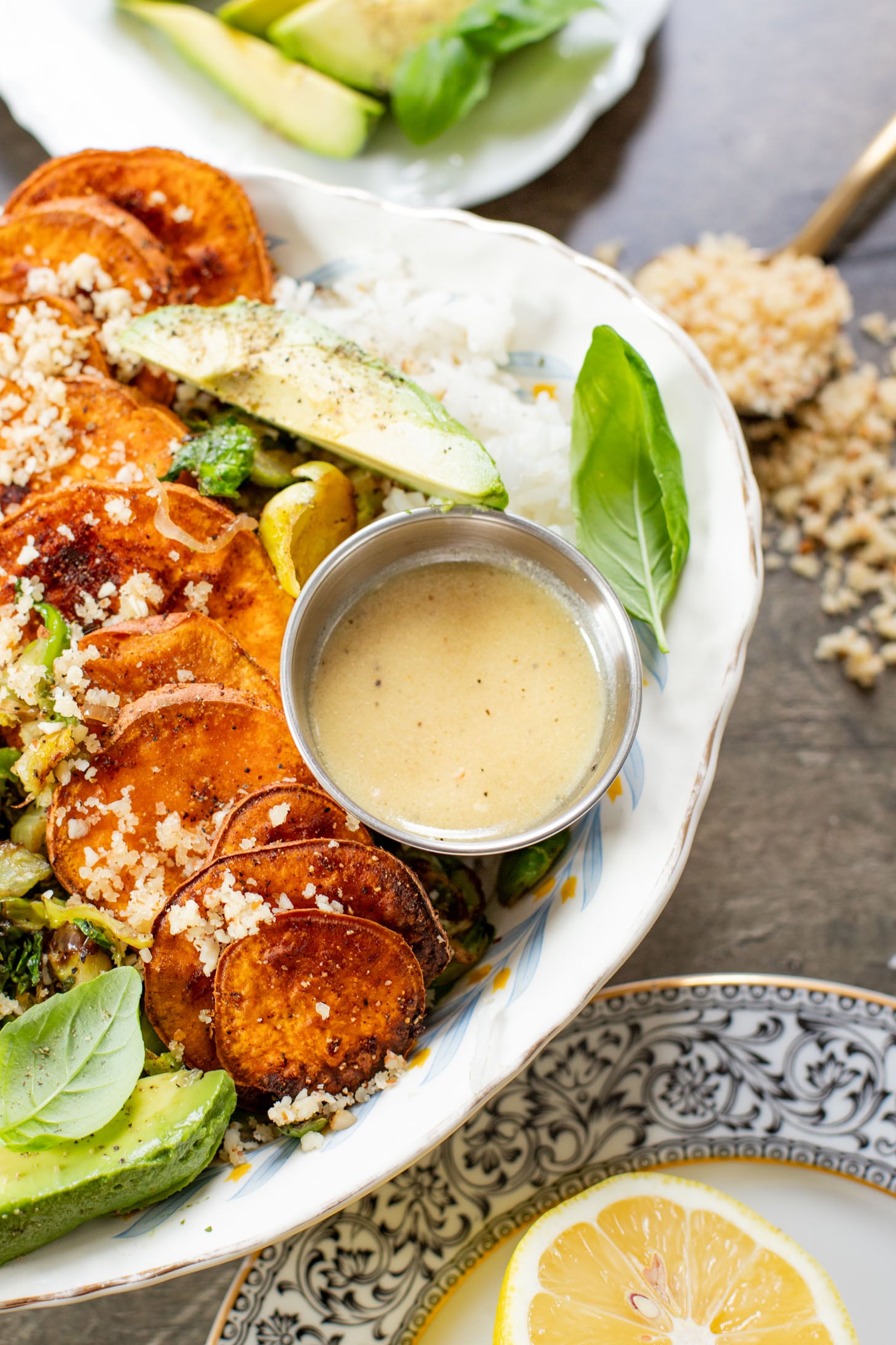 This Harvest Bowl with Maple Dijon Dressing is layered with rice, roasted sweet potatoes, crispy brussels sprouts, almond breadcrumbs & a tangy dressing | ThisSavoryVegan.com #thissavoryvegan #harvestbowl #winterrecipes