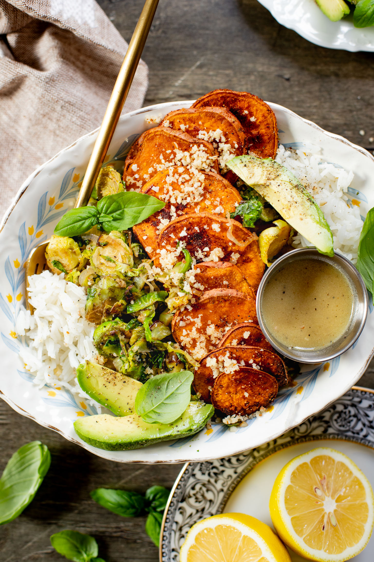 This Harvest Bowl with Maple Dijon Dressing is layered with rice, roasted sweet potatoes, crispy brussels sprouts, almond breadcrumbs & a tangy dressing | ThisSavoryVegan.com #thissavoryvegan #harvestbowl #winterrecipes