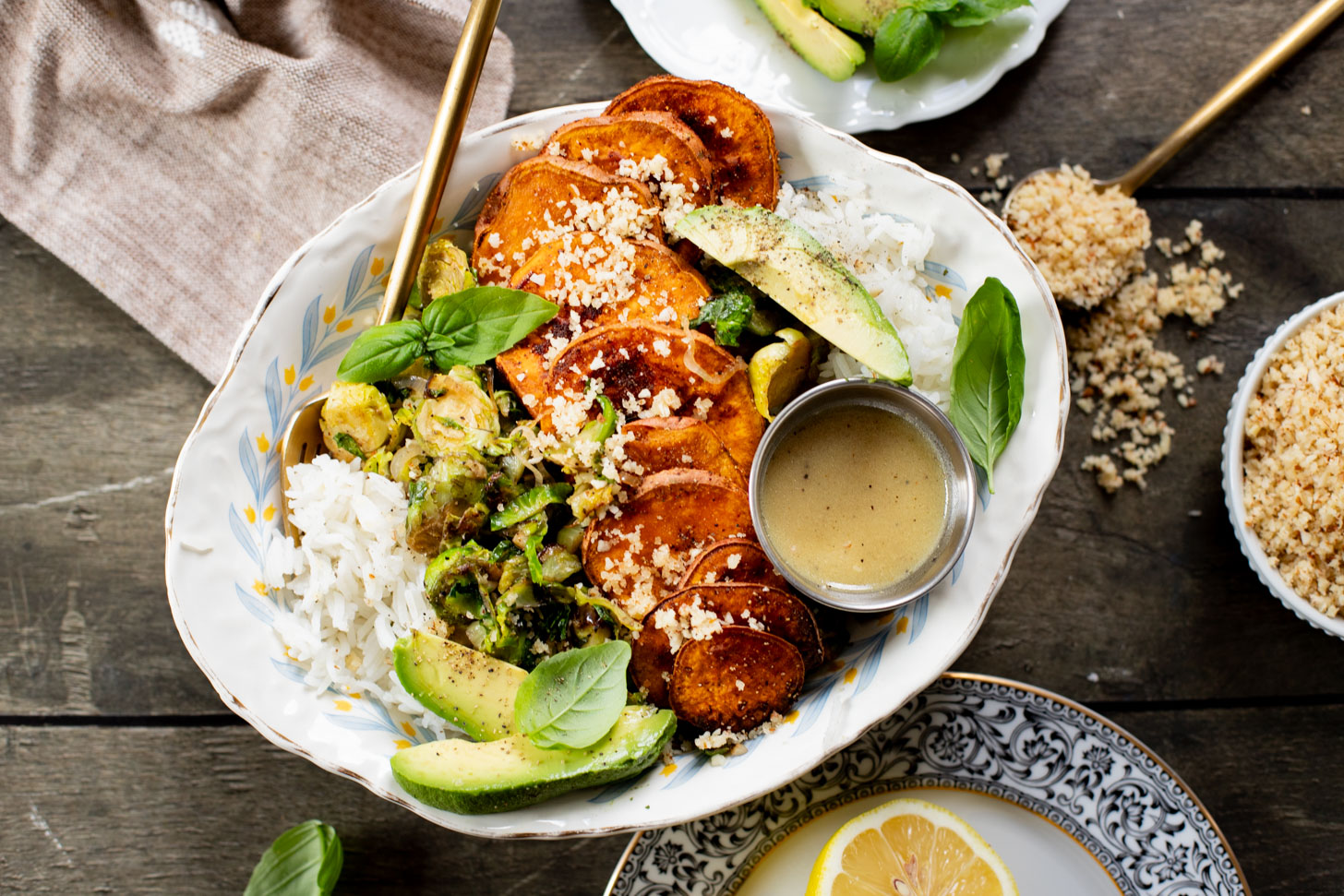 This Harvest Bowl with Maple Dijon Dressing is layered with rice, roasted sweet potatoes, crispy brussels sprouts, almond breadcrumbs & a tangy dressing | ThisSavoryVegan.com #thissavoryvegan #harvestbowl #winterrecipes
