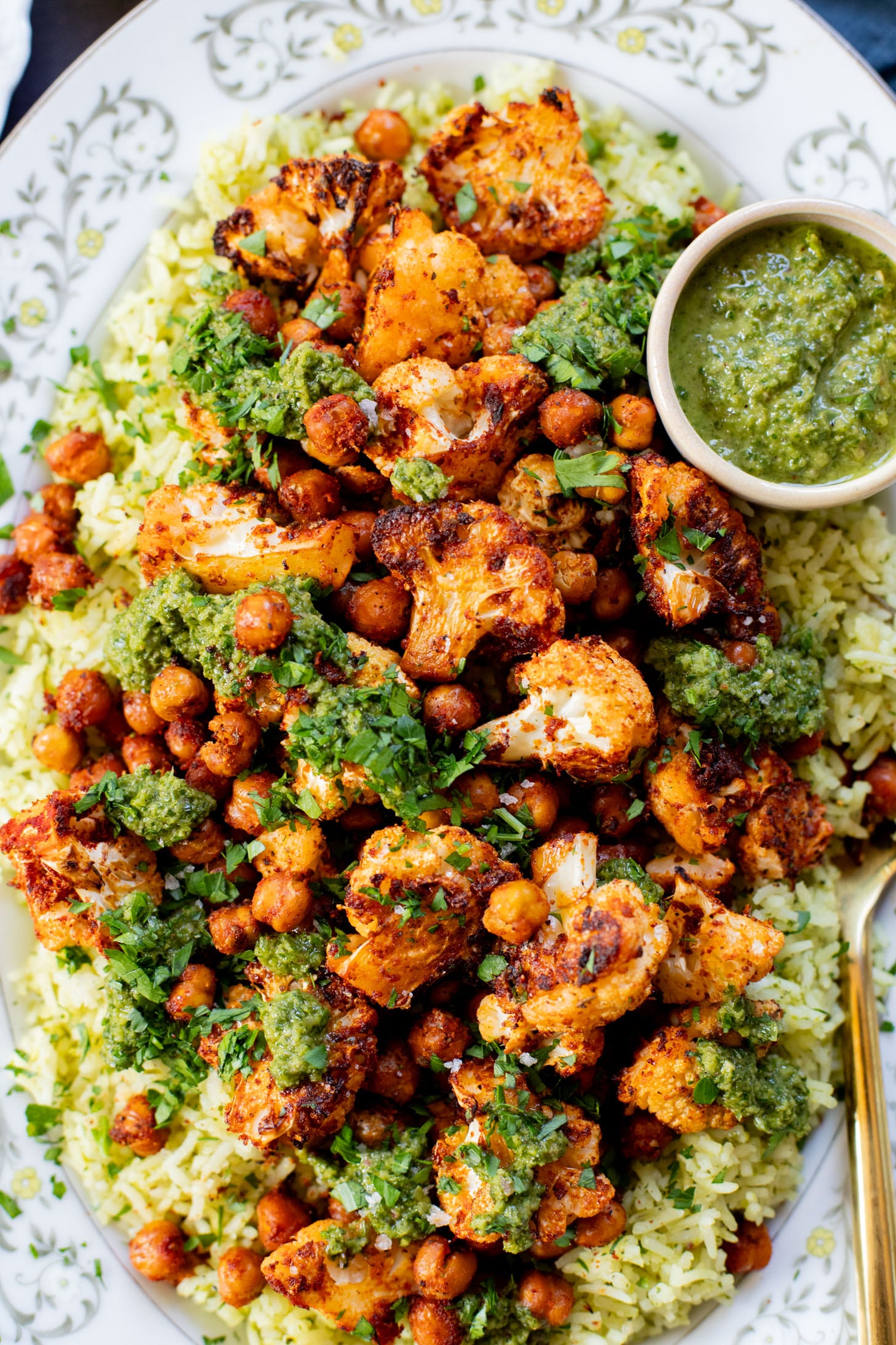 This Roasted Cauliflower with Chimichurri Rice is a flavor packed meal! Cauliflower & chickpeas seasoned and roasted until crispy over herby rice | ThisSavoryVegan.com #chimichurrirecipe #roastedcauliflower #veggiedinner