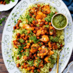 This Roasted Cauliflower with Chimichurri Rice is a flavor packed meal! Cauliflower & chickpeas seasoned and roasted until crispy over herby rice | ThisSavoryVegan.com #chimichurrirecipe #roastedcauliflower #veggiedinner